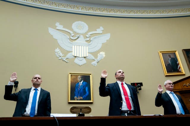 <p>Ryan Graves, Americans for Safe Aerospace Executive Director, from left, U.S. Air Force (Ret.) Maj. David Grusch, and U.S. Navy (Ret.) Cmdr. David Fravor, are sworn in during a House Oversight and Accountability subcommittee hearing on UFOs, Wednesday, July 26, 2023, on Capitol Hill in Washington</p>