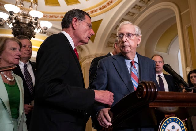 <p>Sen John Barrasso (R-WY) reaches out to help Senate Minority Leader Mitch McConnell (R-KY) after McConnell froze and stopped talking at the microphones during a news conference</p>