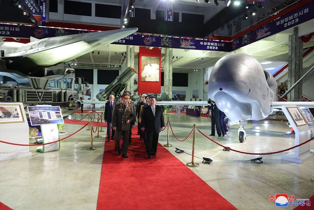 <p>North Korean leader Kim Jong-un and Russian defence minister Sergei Shoigu walking past a drone resembling a US Global Hawk model</p>