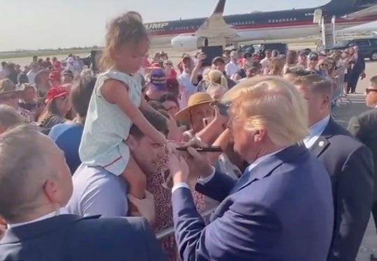 Trump scrawls on a little girl’s hand in permanent marker