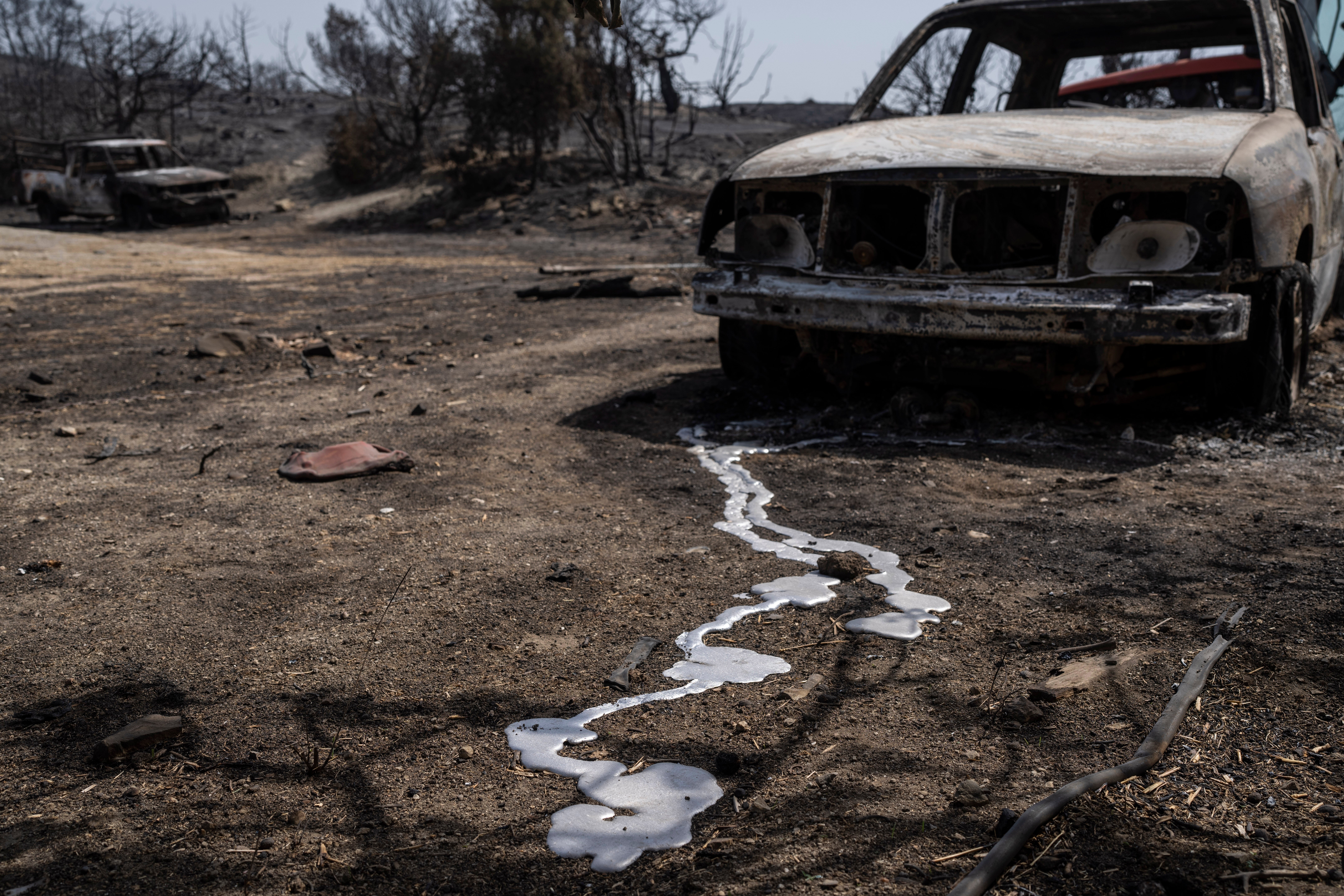 Burnt cars are seen after a wildfire near Gennadi village, on the Aegean Sea island of Rhodes