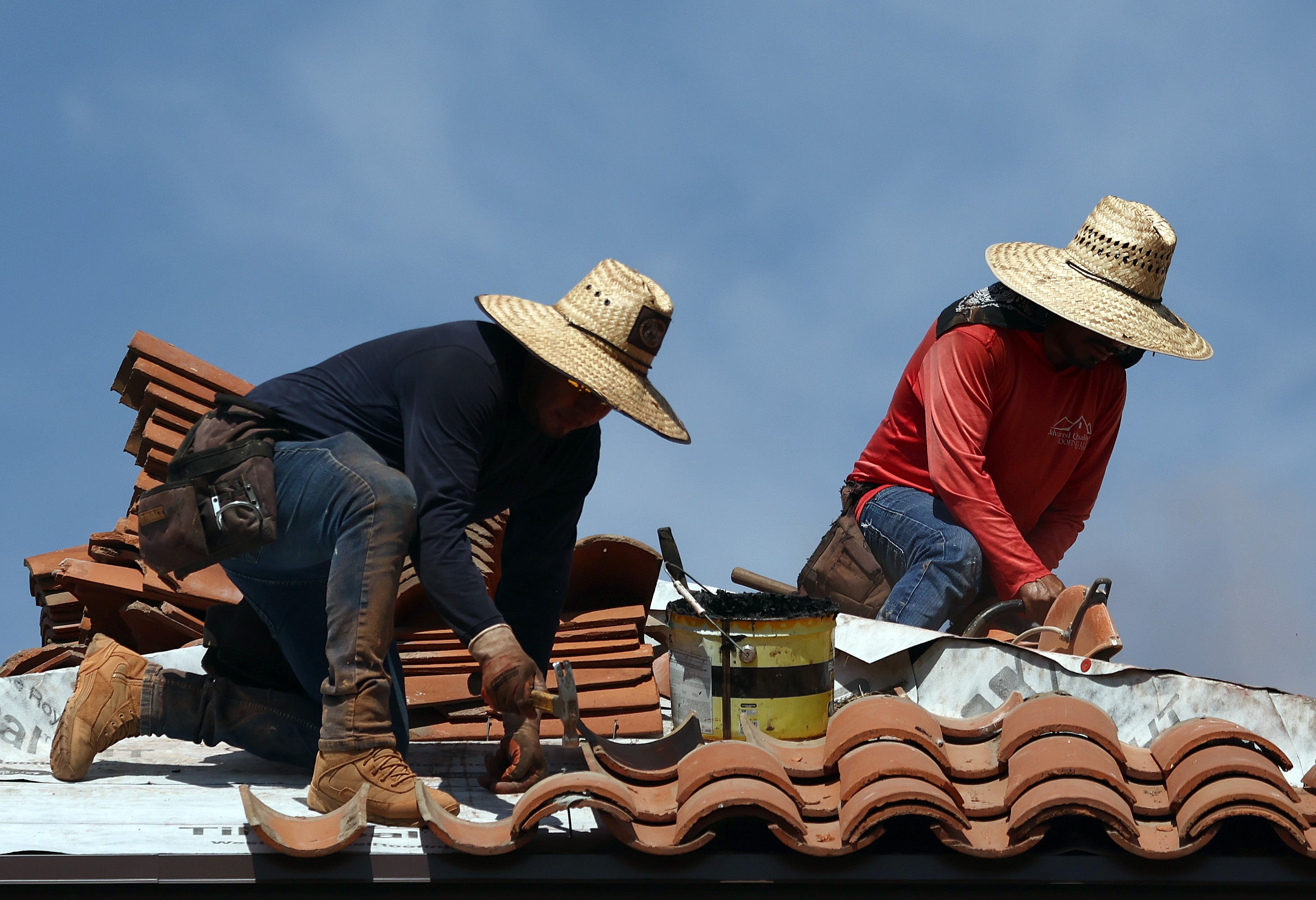 <p>People work on the roof of a church amid the city’s worst heatwave on record on July 26, 2023 in Phoenix, Arizona. The city has been above 110F every day this month</p>