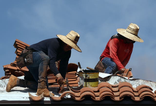 <p>People work on the roof of a church amid the city’s worst heatwave on record on July 26, 2023 in Phoenix, Arizona. The city has been above 110F every day this month</p>