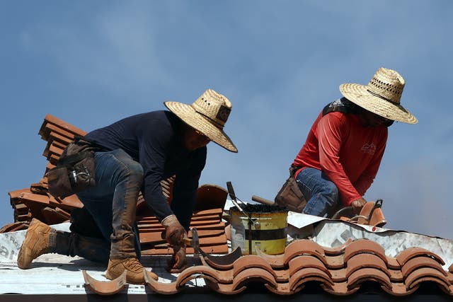 <p>People work on the roof of a church amid the city’s worst heatwave on record on July 26, 2023 in Phoenix, Arizona. The city has been above 110F every day this month</p>