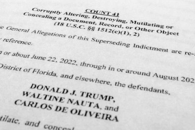 <p>The updated indictment against former President Donald Trump, Walt Nauta and Carlos De Oliveira is photographed Thursday</p>