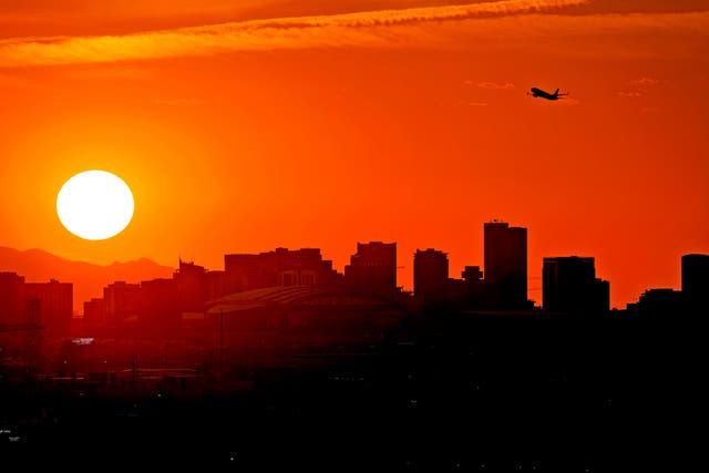 <p>A jet takes flight from Sky Harbor International Airport as the sun sets over Phoenix, Arizona, on July 12, 2023</p>