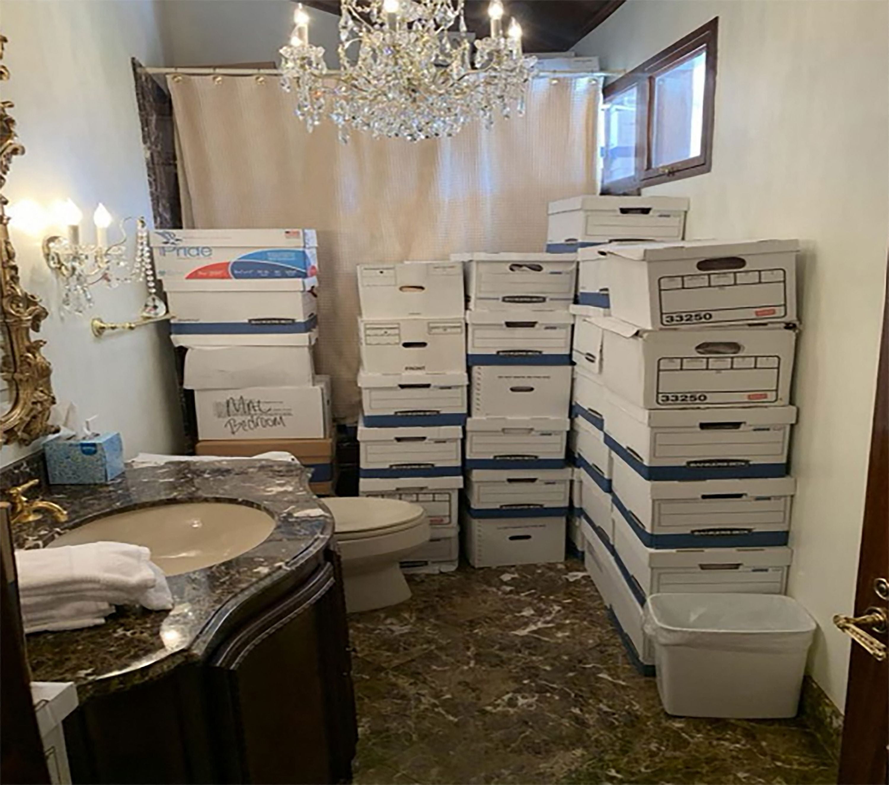 In this handout photo provided by the US Department of Justice, stacks of boxes can be observed in a bathroom and shower in The Mar-a-Lago Club’s Lake Room at former US President Donald Trump’s Mar-a-Lago estate in Palm Beach, Florida