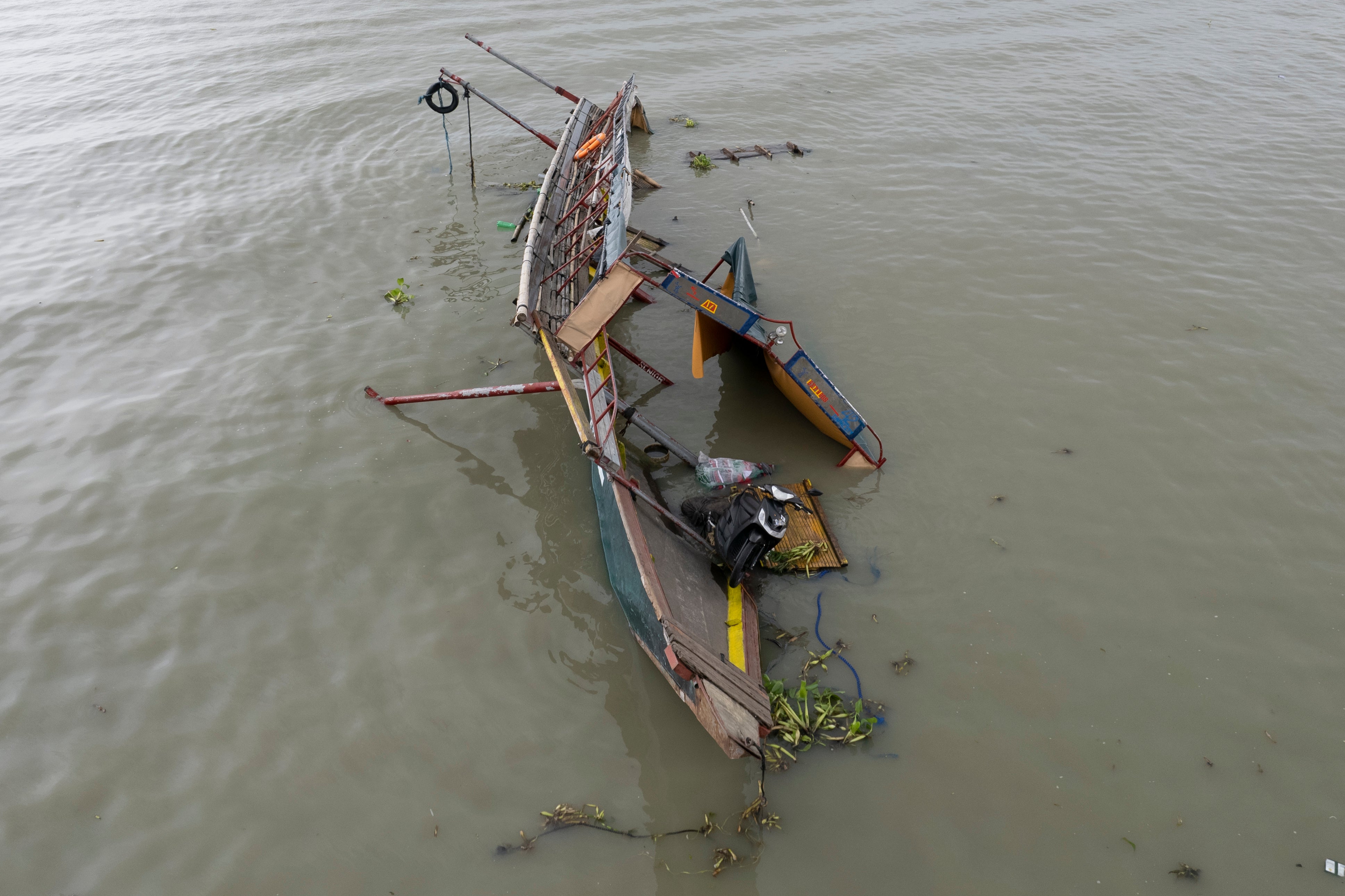This photo taken by drone shows the remains of a passenger boat that capsized in Binangonan, Rizal province, Philippines on Friday