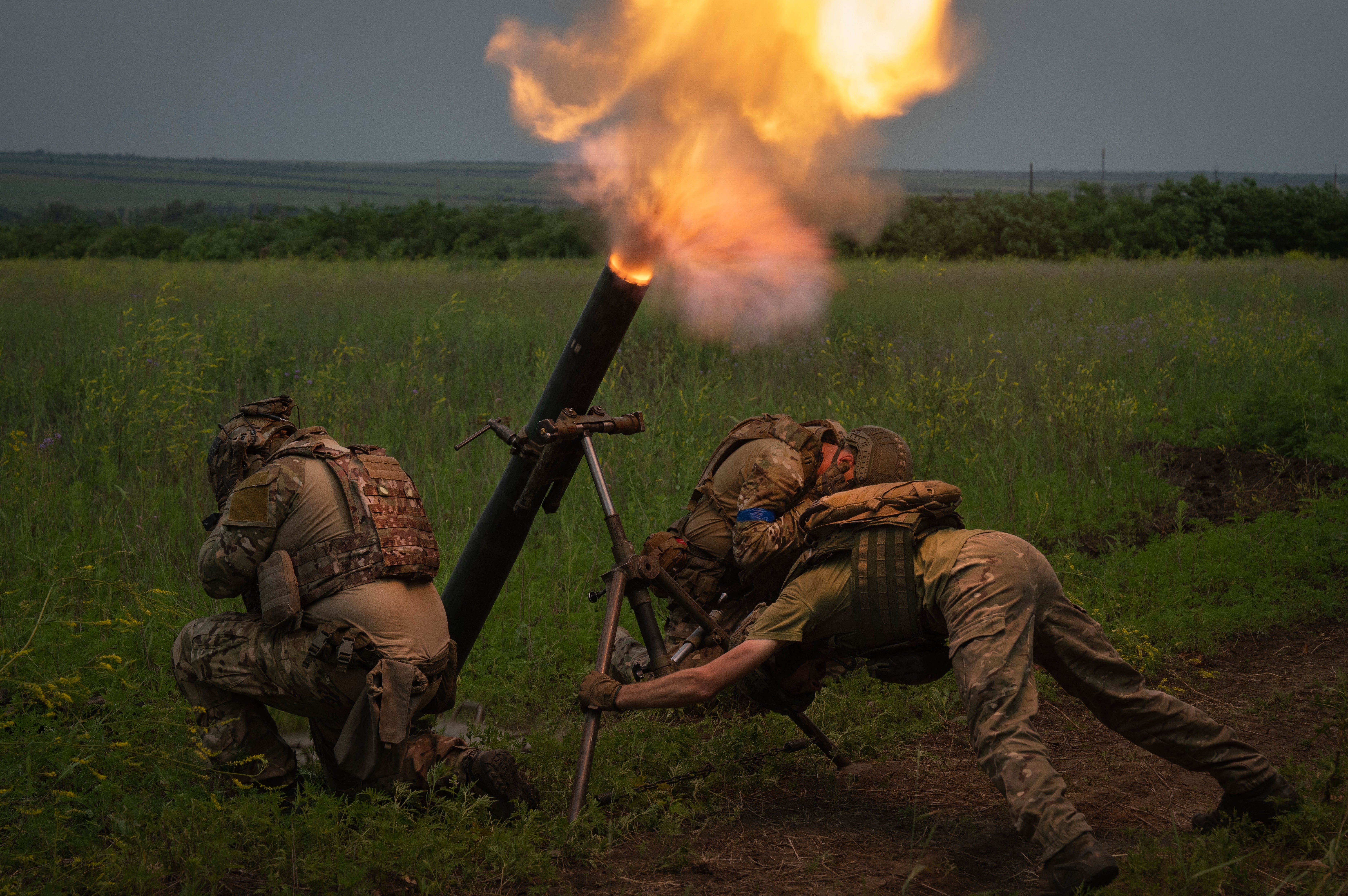 Ukrainian soldiers fire toward Russian position on the front line in Zaporizhzhia region
