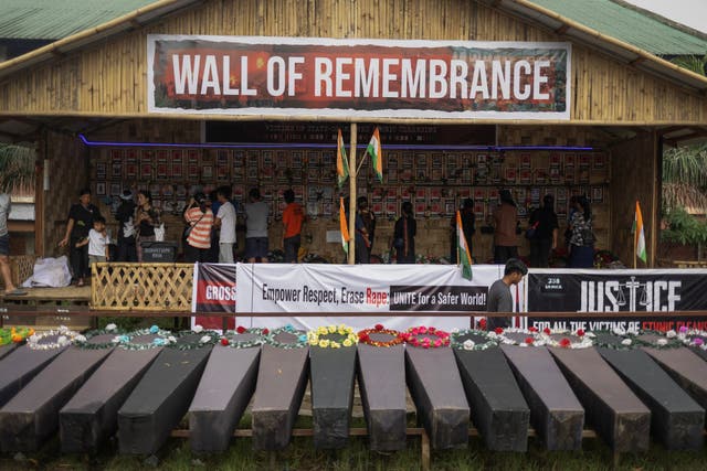 <p>Kuki people look at the pictures of those they claim have died in ethnic violence, at a protest site in Churachandpur district, Manipur</p>