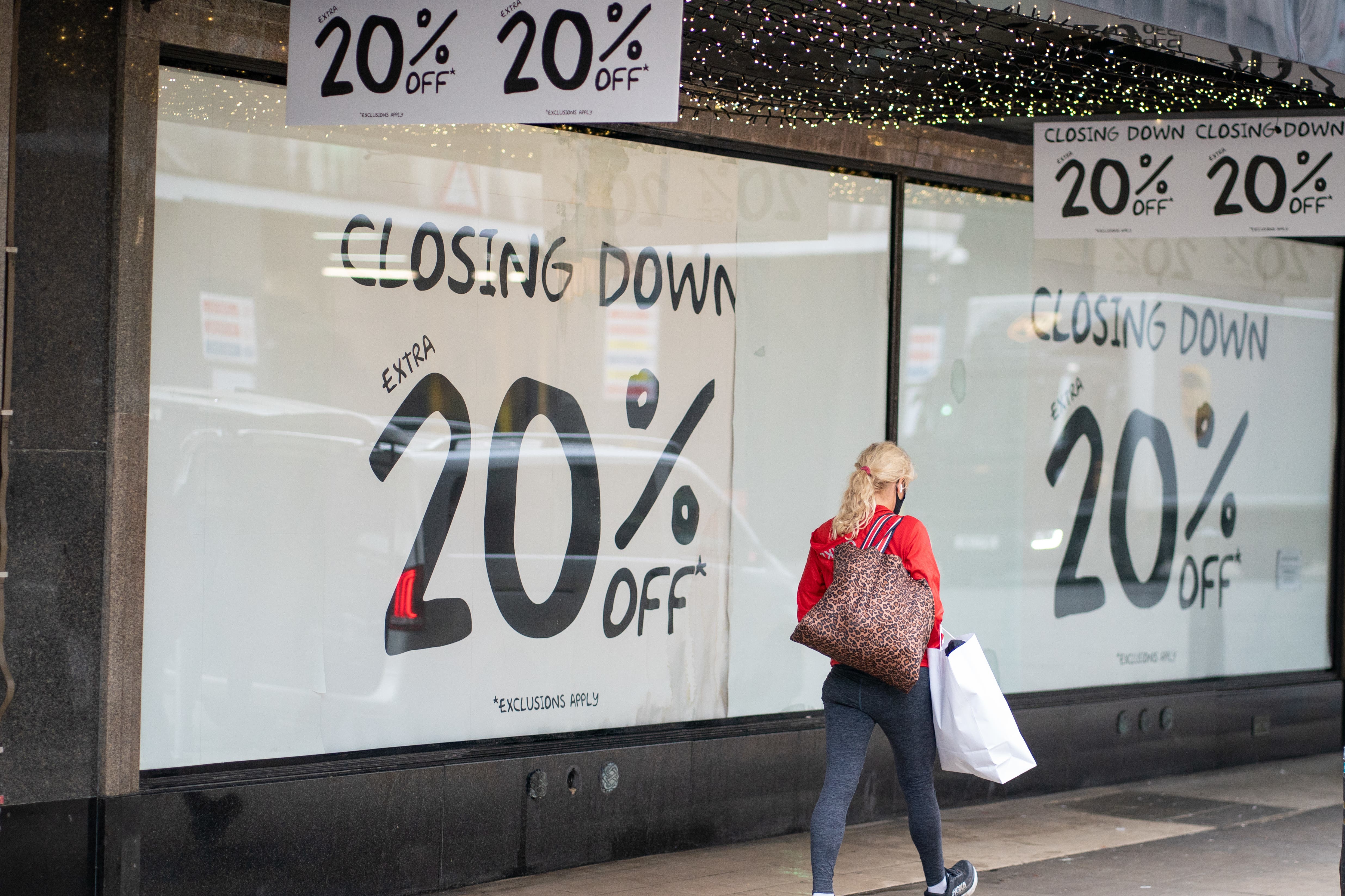 A shopper passes a closing down sale sign (PA)