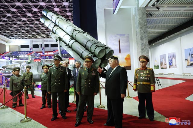 <p>North Korean Supreme Leader Kim Jong-un (C-R) speaking with Russian Federation defence minister Sergei Shoigu (C-L) during a visit to the Weaponry Exhibition in Pyongyang</p>