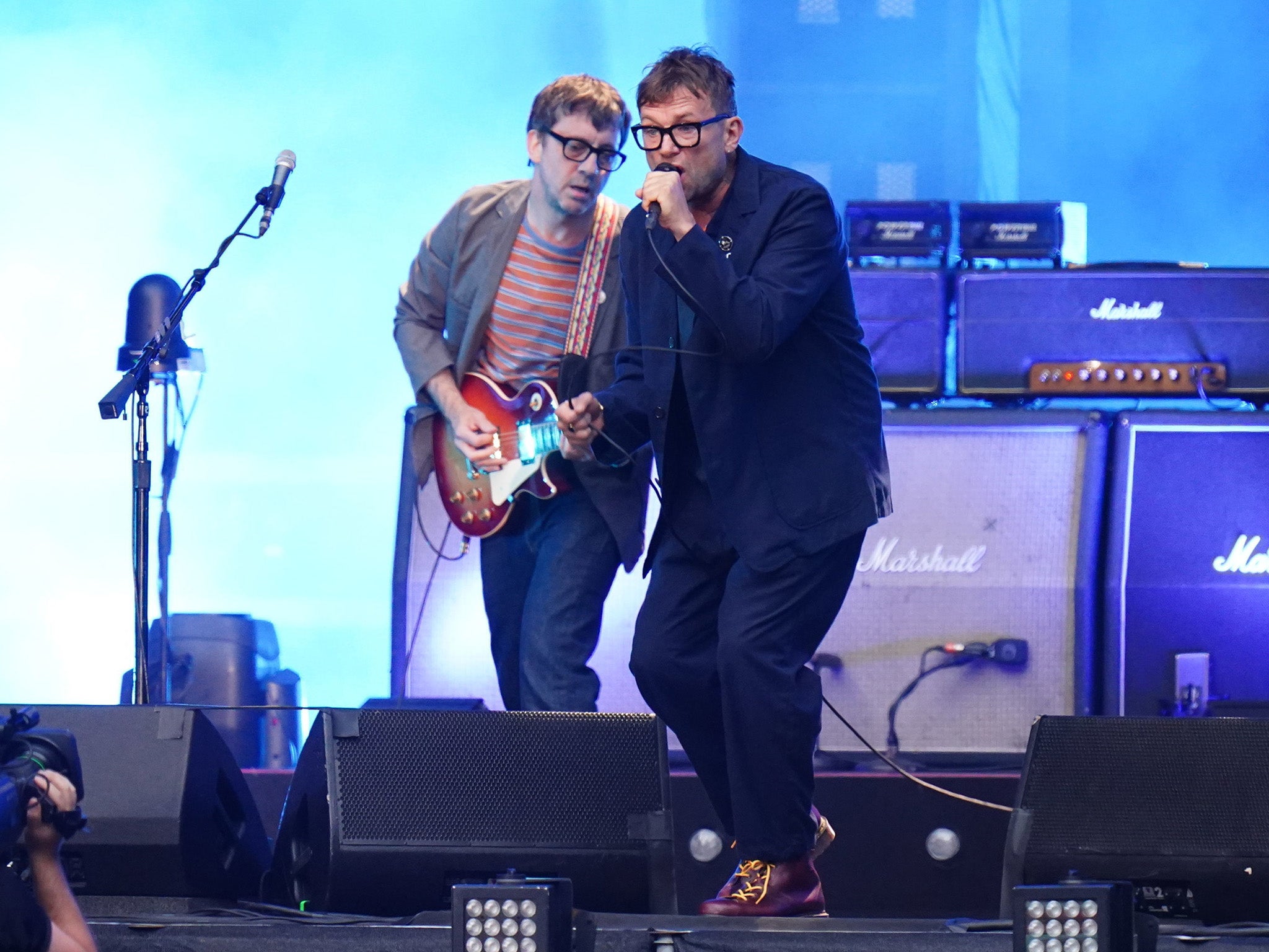 Graham Coxon and Damon Albarn of Blur performing on stage at Wembley Stadium in London