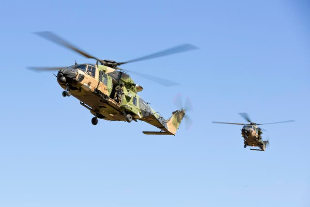 <p>Army MRH-90 Taipan helicopters prepare to land at Townsville, Australia</p>