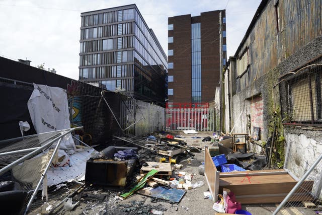 The remains of a migrant camp in Sandwith Street, Dublin, following a protest in May where it was dismantled and later set alight (Niall Carson/PA)
