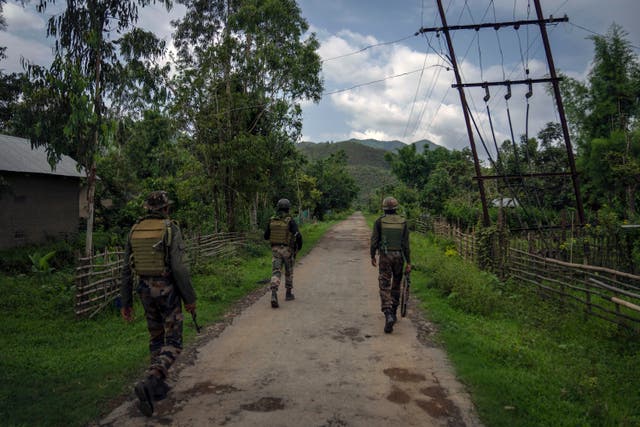 <p>File. Indian army soldiers patrol a deserted village in Churachandpur, in the northeastern Indian state of Manipur</p>