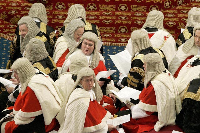 Law Lords sit on the cross benches as they wait in the House of Lords to hear Britain’s Queen Elizabeth II read the Queen’s Speech for the State Opening of Parliament in London.