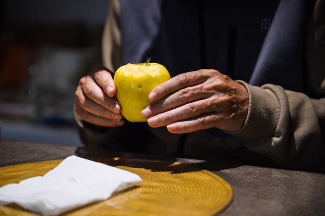 <p>Alzheimer’s patient Jean-Marie (R) holds an apple at “Les Papillons de Marcelle” house, in Arles, southeastern France, on May 9, 2023</p>