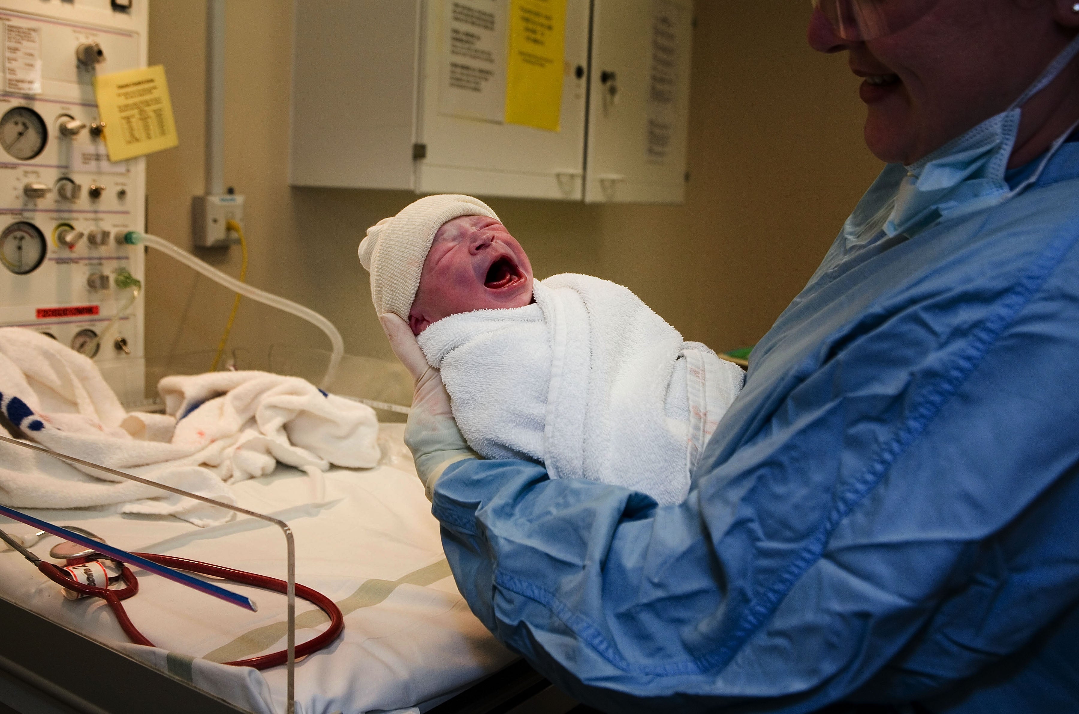 File: In this file photograph dated 6 March 2007, a young boy is weighed after being born in an NHS maternity unit, in Manchester, England