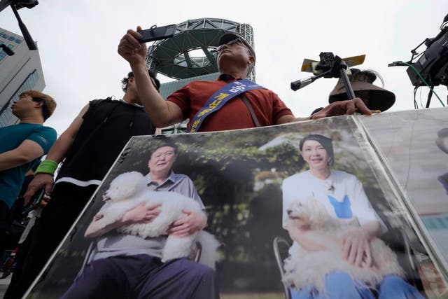 <p>File: Activists carrying photo showing South Korean President Yoon Suk-yeol, left, and his wife Kim Keon-hee</p>