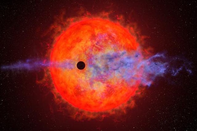 <p>Artist’s illustration shows a planet (dark silhouette) passing in front of the red dwarf star AU Microscopii</p>
