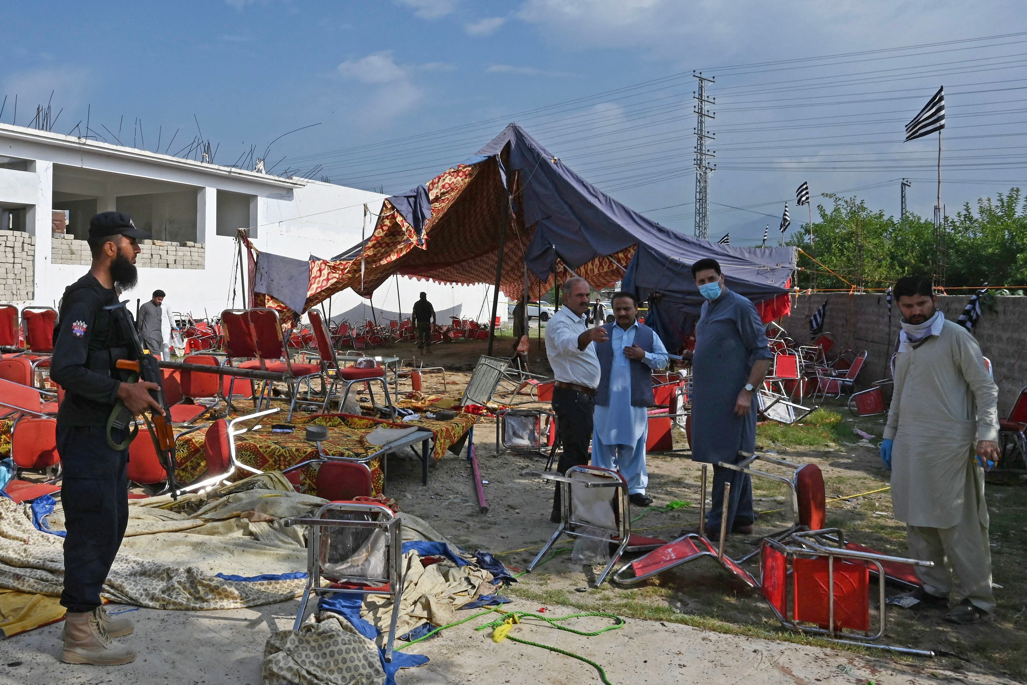 Security personnel examine the site of a bomb blast in Bajaur district