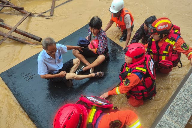 <p>Rescuers evacuate residents in a flooded area after Typhoon Doksuri’s landfall in Quanzhou, in China’s eastern Fujian province</p>