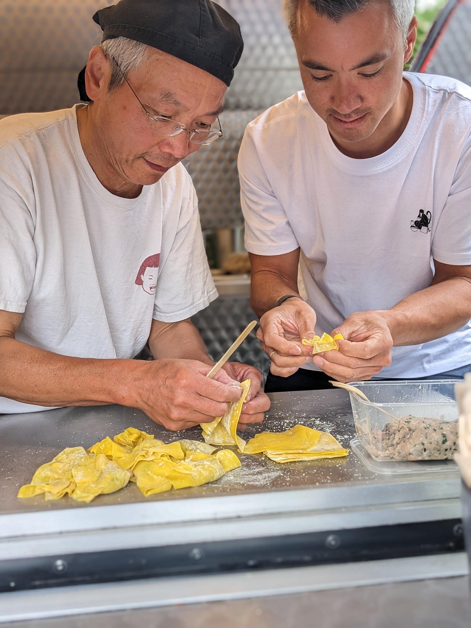 Yeung (R) and his father making wontons
