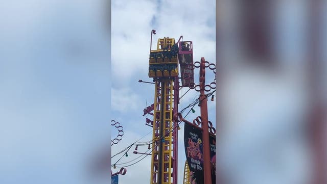 <p>Rescuers scramble to aid people stuck at top of 22-metre rollercoaster</p>