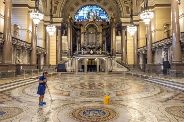 Louise Brewis cleans the Minton floor at St George’s Hall, Liverpool, before it goes on display to the public (Peter Byrne/PA)