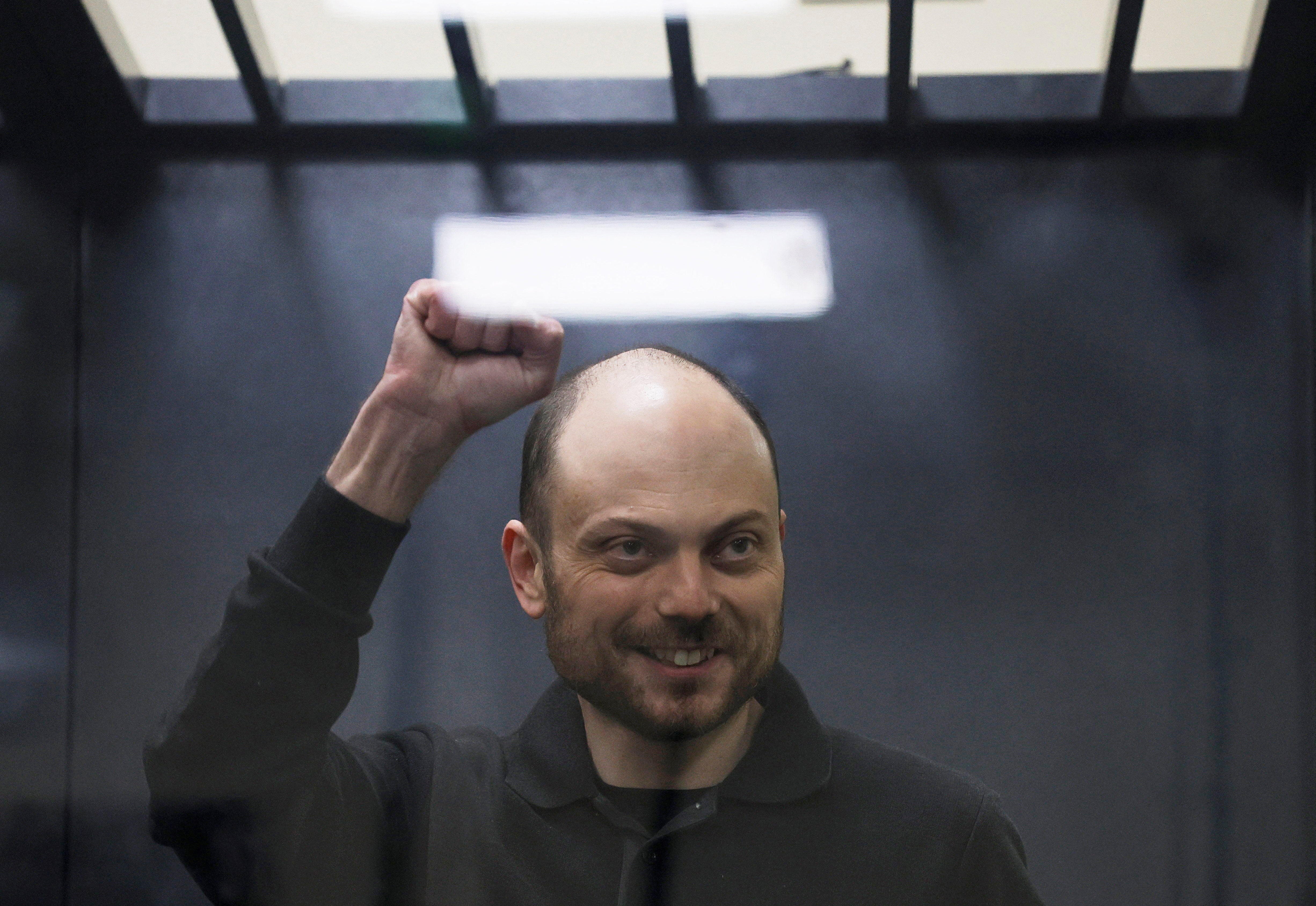Jailed Russian opposition figure Vladimir Kara-Murza gestures as he stands behind a glass wall of an enclosure for defendants during a court hearing to consider an appeal against his prison sentence, in Moscow, Russia 31 July 2023