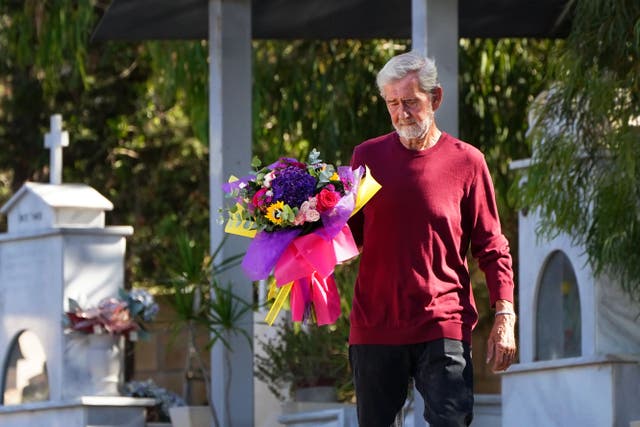 David Hunter lays flowers at the grave of his wife Janice Hunter (Victoria Jones/PA)