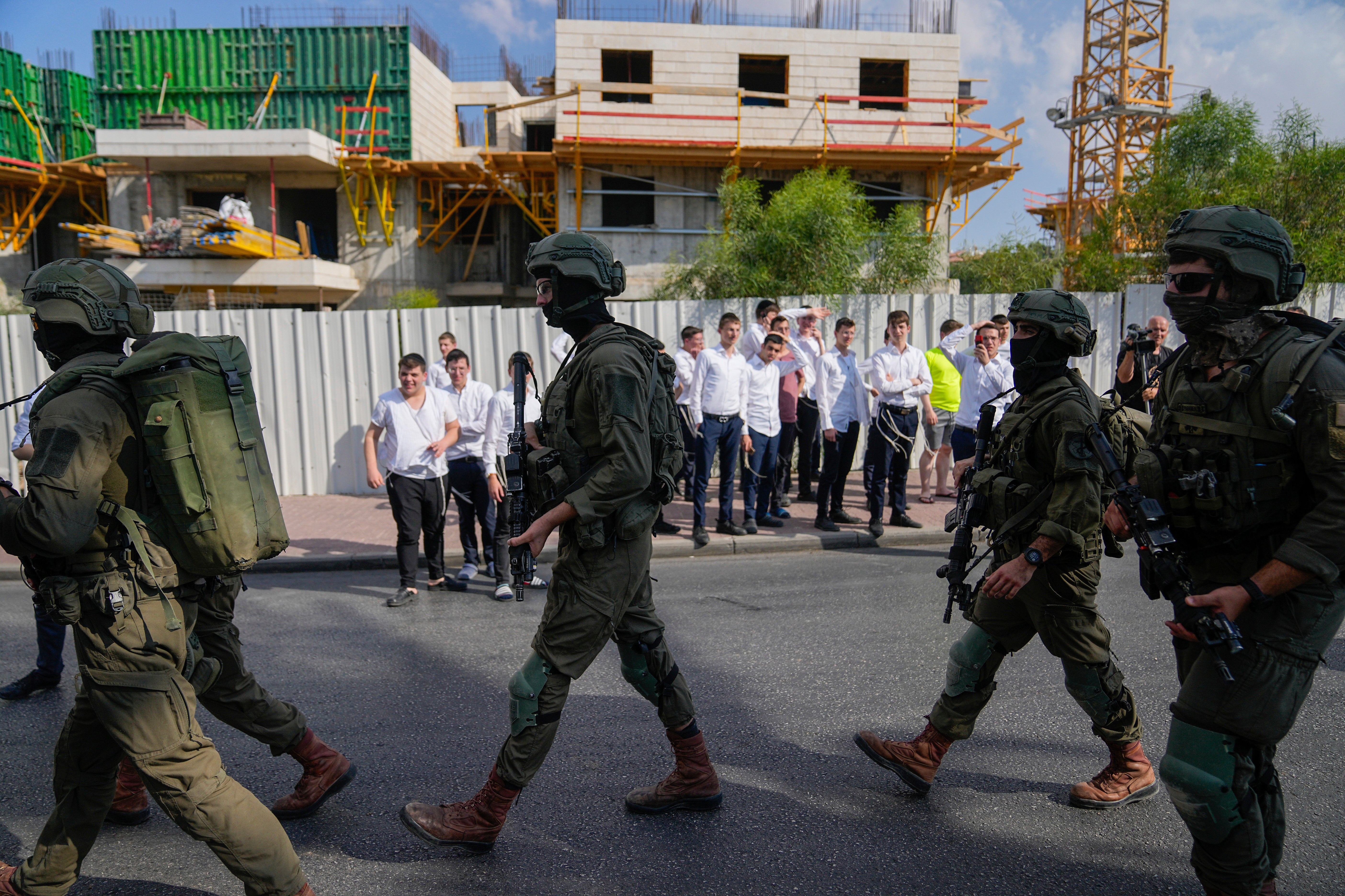 Israeli security forces are seen deployed at the site of a shooting attack in the West Bank Israeli settlement of Maale Adumim, Tuesday, Aug 1, 2023