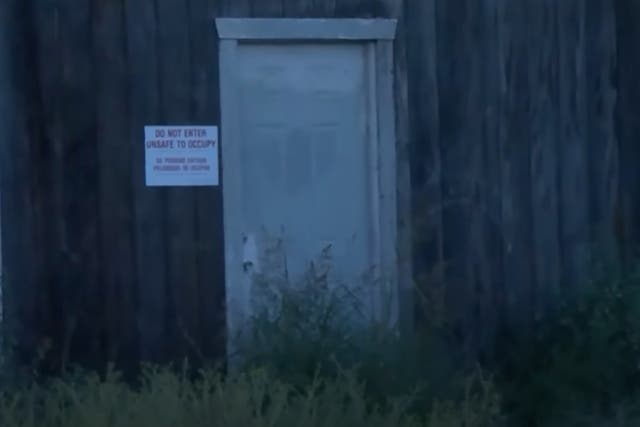 <p>A warning sign is posted outside a warehouse near Fresno, California, where county officials found an illegal lab operating inside</p>