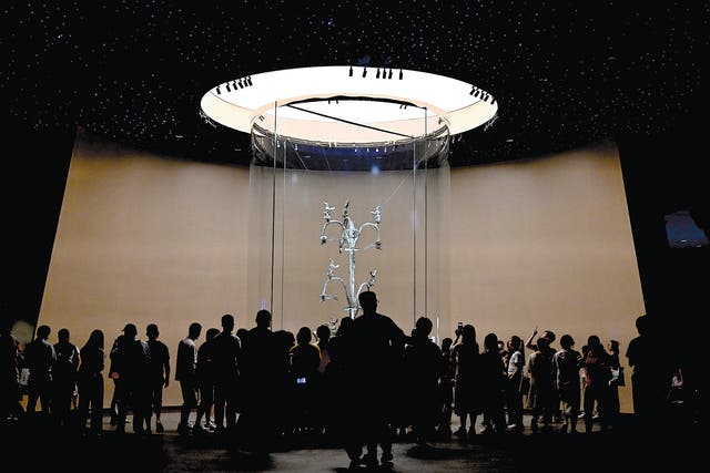 <p>Visitors admire the 12.99ft bronze “holy tree” at the Sanxingdui Museum in Guanghan, Sichuan province, on July 27, 2023, as the museum’s star relic now occupies a more spacious hall created during the construction of the new venue</p>