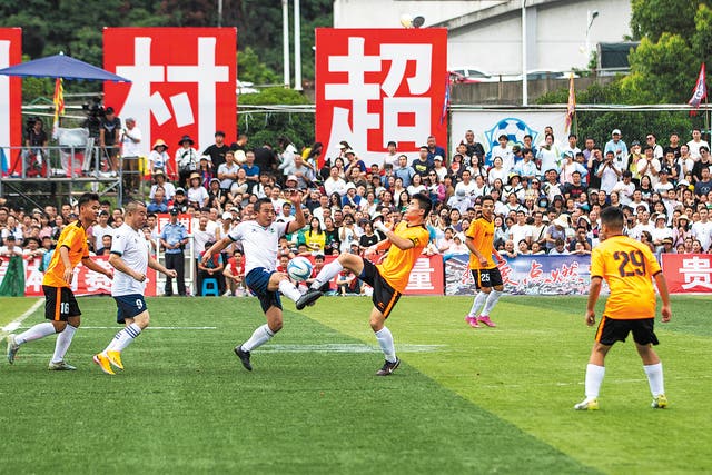 <p>Two village teams play in a Village Super League match in Rongjiang county, Guizhou province, in June 2023 </p>