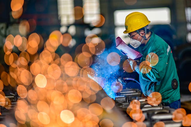 <p>A worker welds materials at a factory in Qingzhou, Shandong province, on July 17 </p>