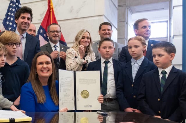 <p>Arkansas Governor Sarah Huckabee Sanders smiling after signing child labour law into effect on 8 March</p>