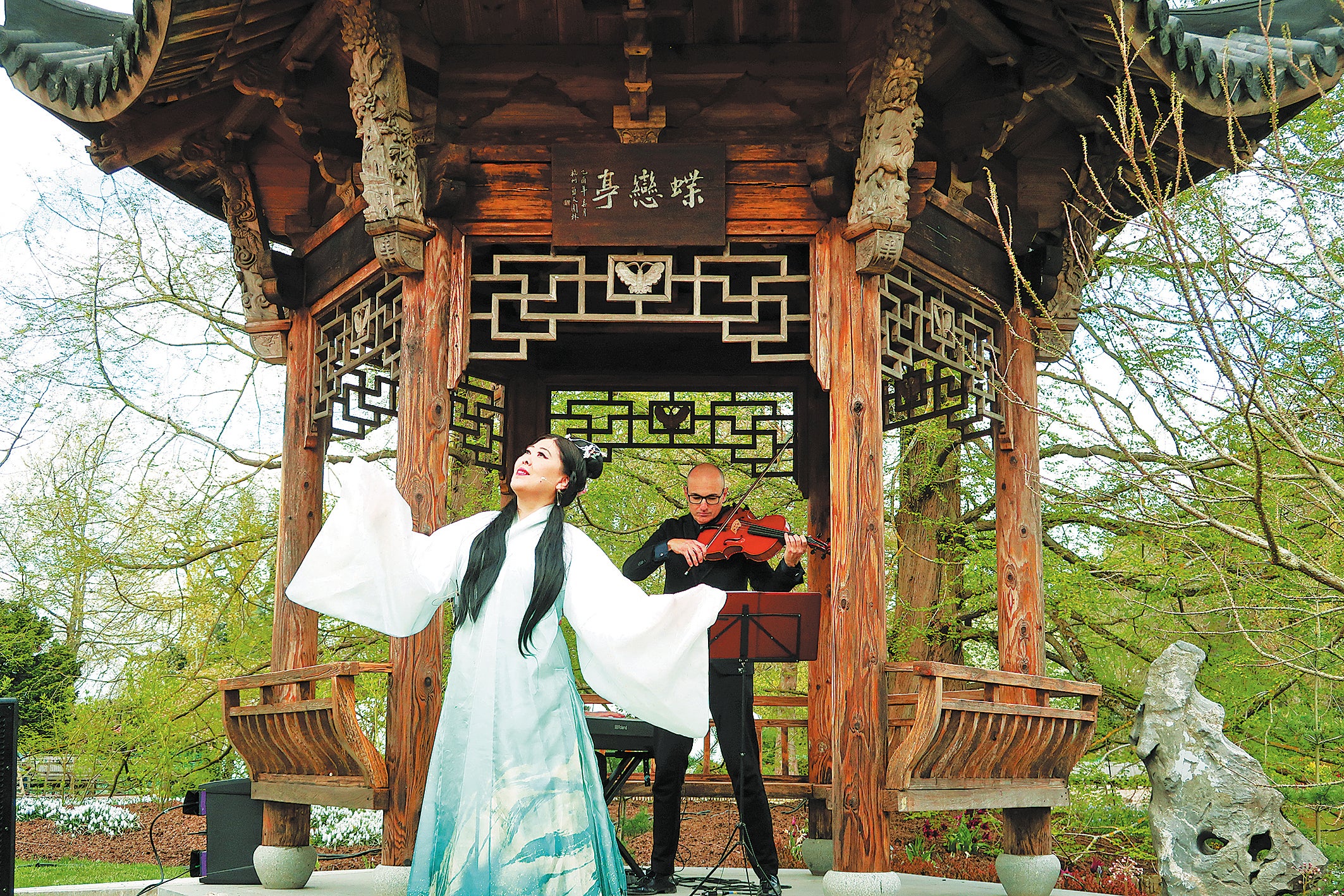 A singer performs in front of the Butterfly Lovers Pavilion at Wisley, Surrey, in April 2023