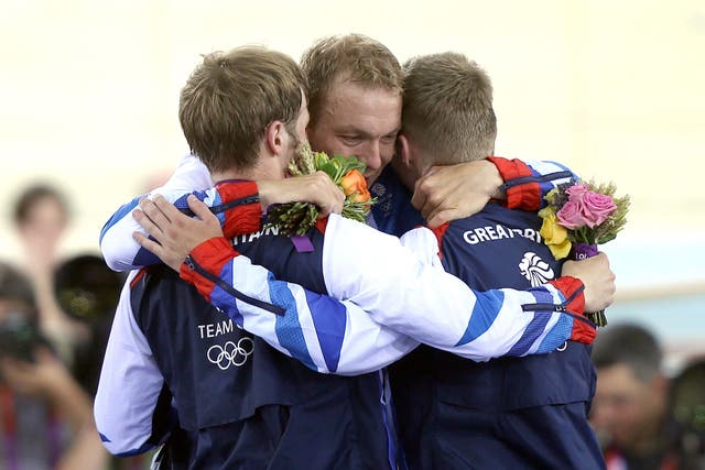 Great Britain’s Sir Chris Hoy embraces Jason Kenny (left) and Philip Hindes (David Davies/PA)