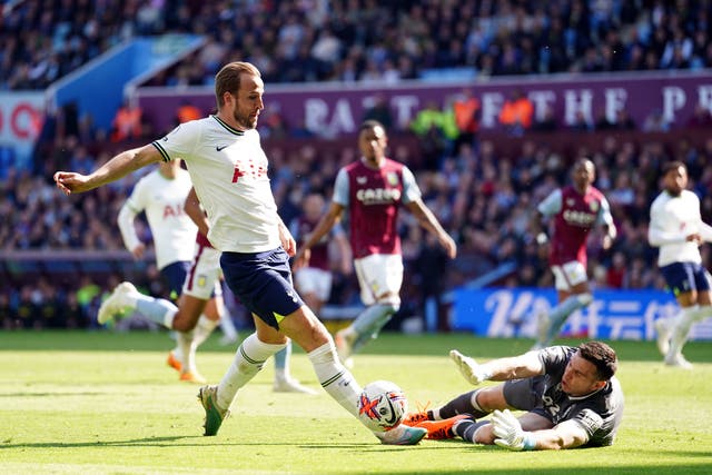 Tottenham’s Harry Kane goes down under a challenge from Aston Villa goalkeeper Emiliano Martinez (PA)