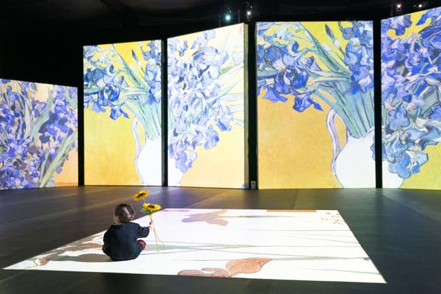 A toddler looking at images from the Van Gogh Alive experience in Edinburgh (Jane Barlow/PA)