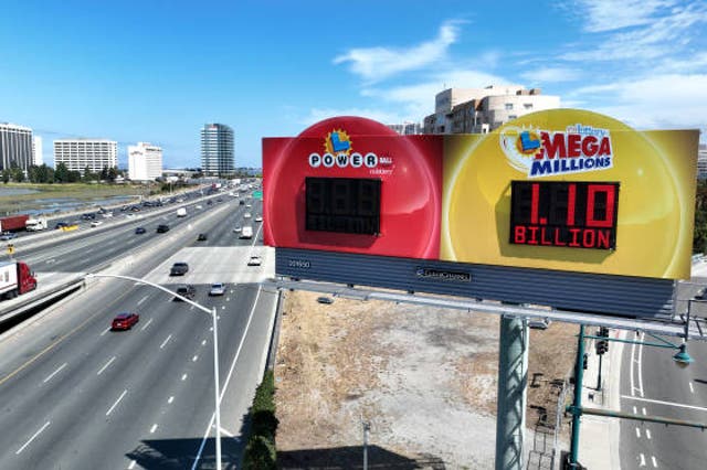 <p> In an aerial view, a billboard advertises a Mega Millions lottery valued at over $1bn on 1 August 2023 in Emeryville, California</p>