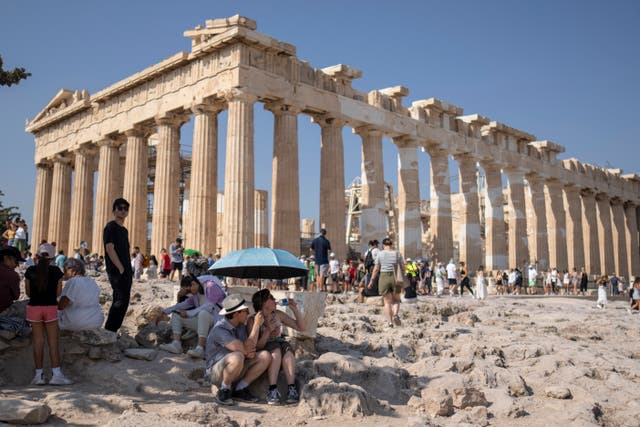 <p>Tourists cope with a heatwave in July at the Parthenon in Athens, Greece. The UN confirmed this week that this summer was the world’s hottest on record </p>