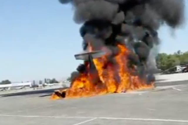 <p>The wreckage of a small plane burns on a runway at Van Nuys Airport, in Los Angeles, California, on 2 August, 2023</p>