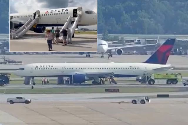 <p>Passengers evacuating the plane after landing in Atlanta </p>