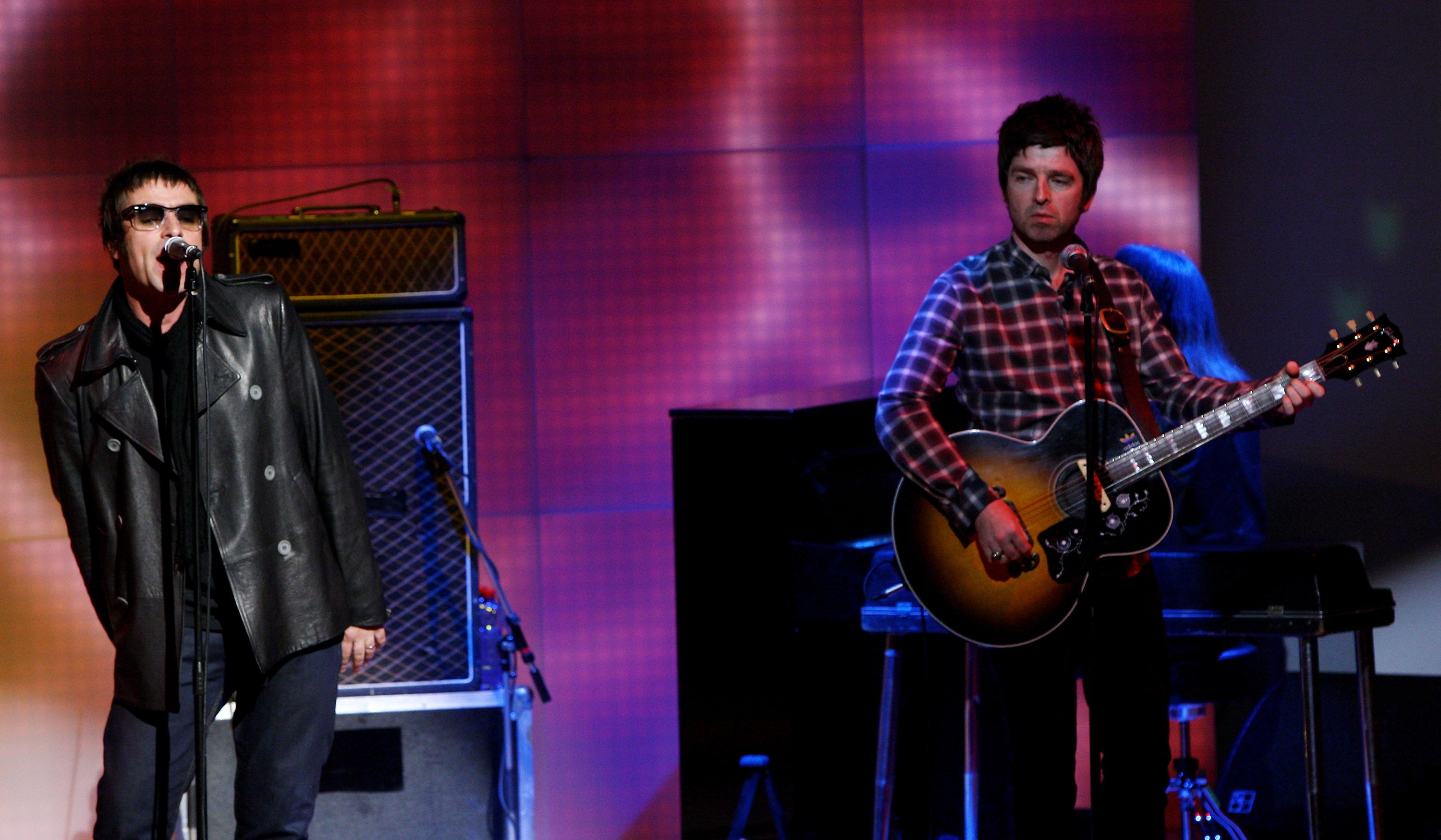 Noel and Liam on stage in 2008, one year before Oasis split
