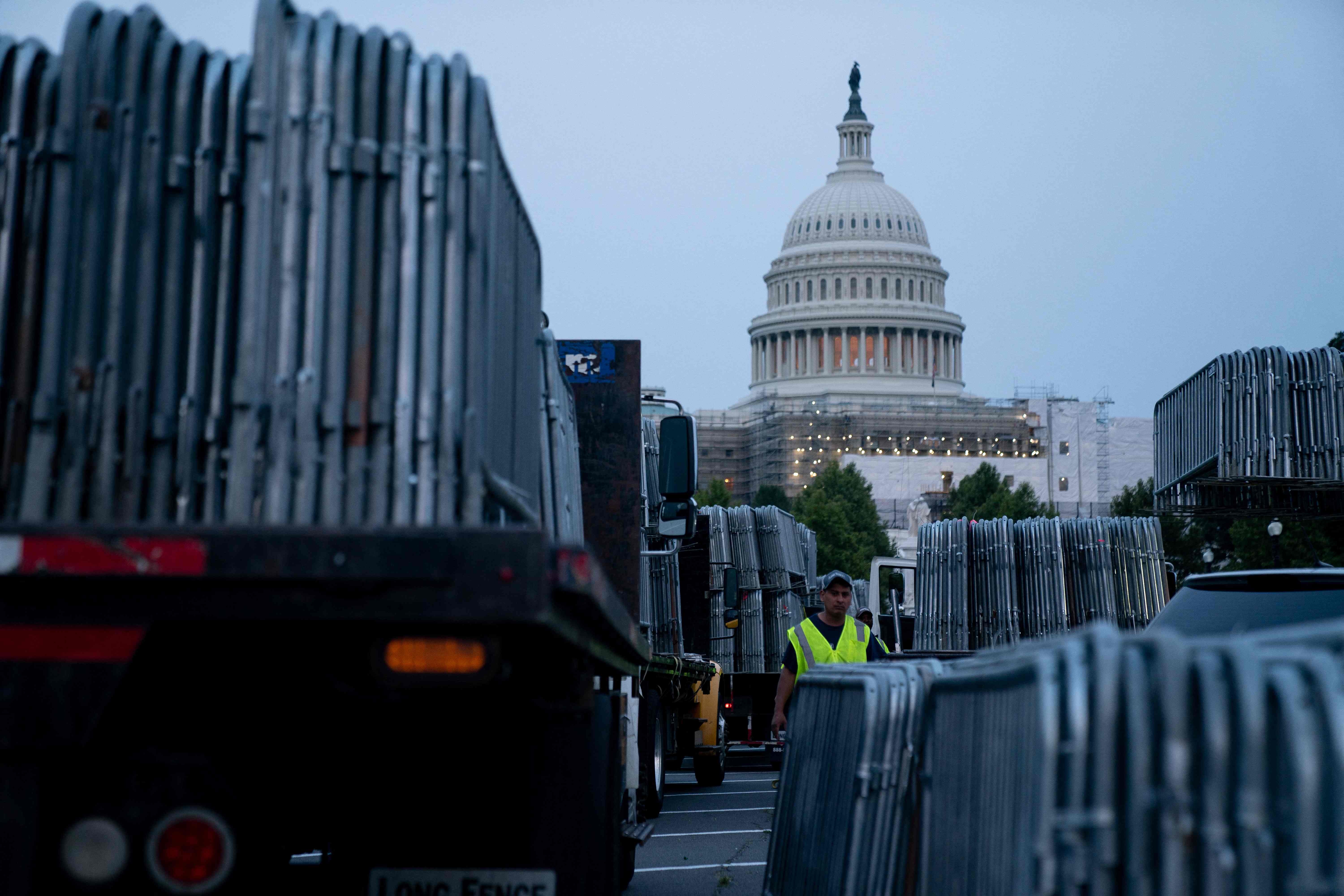 Workers set up security barricades outside the US Capitol in Washington, DC