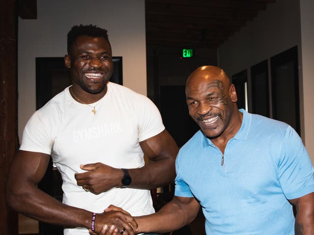 <p>Francis Ngannou, left, with former world heavyweight champion Mike Tyson</p>