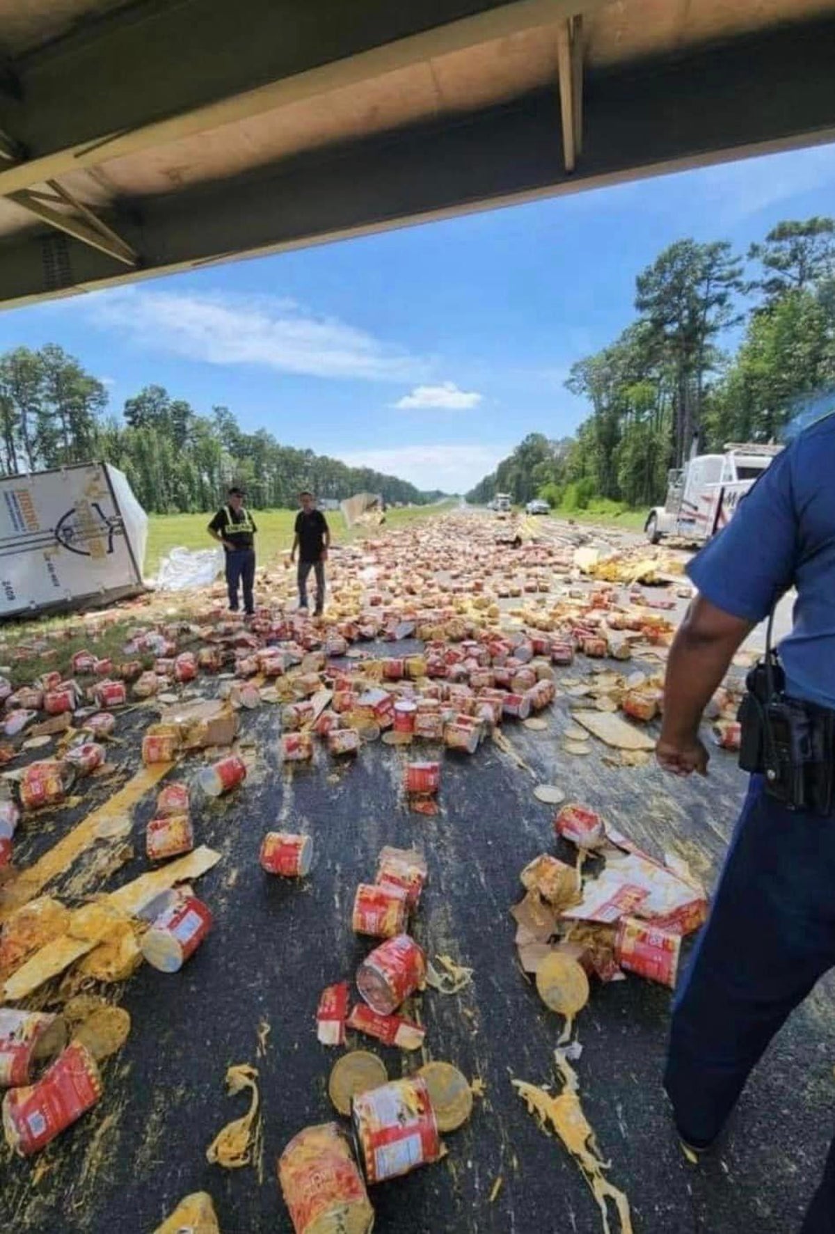 Nacho cheese floods highway after scores of cans tumble from truck